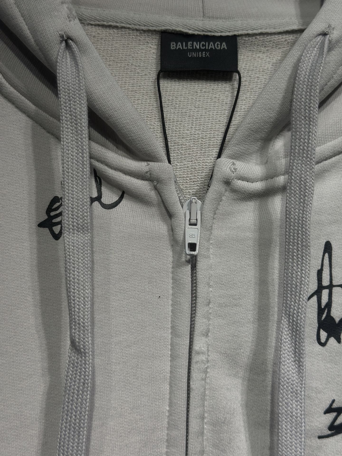 White zip-up hoodie with hood, drawcords, and center front zipper