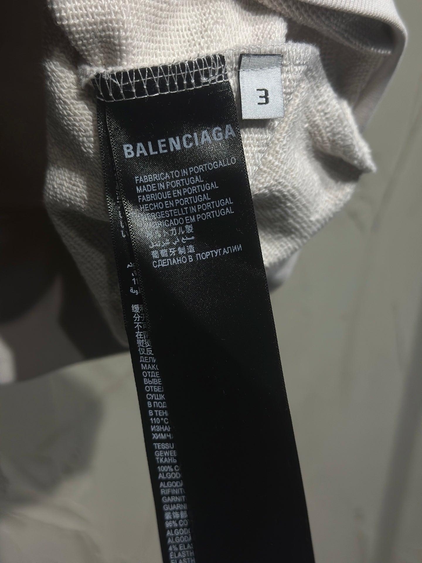 Hoodie size 3 care label with brand text on inner collar