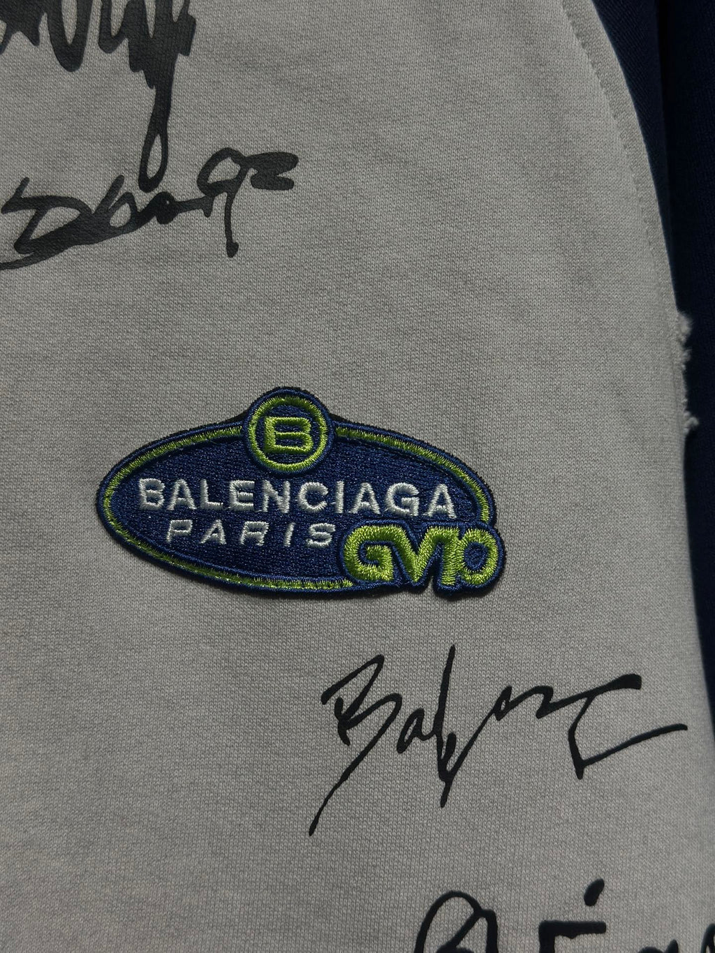 White zip-up hoodie with BALENCIAGA PARIS oval patch and black signature marks