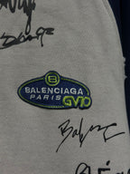 White zip-up hoodie with BALENCIAGA PARIS oval patch and black signature marks