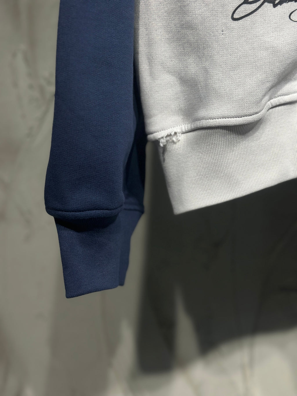 Contrast navy sleeve cuff and white hoodie hem with stitched seam