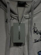 BALENCIAGA hang tag at inside neckline of a white zip-up hoodie