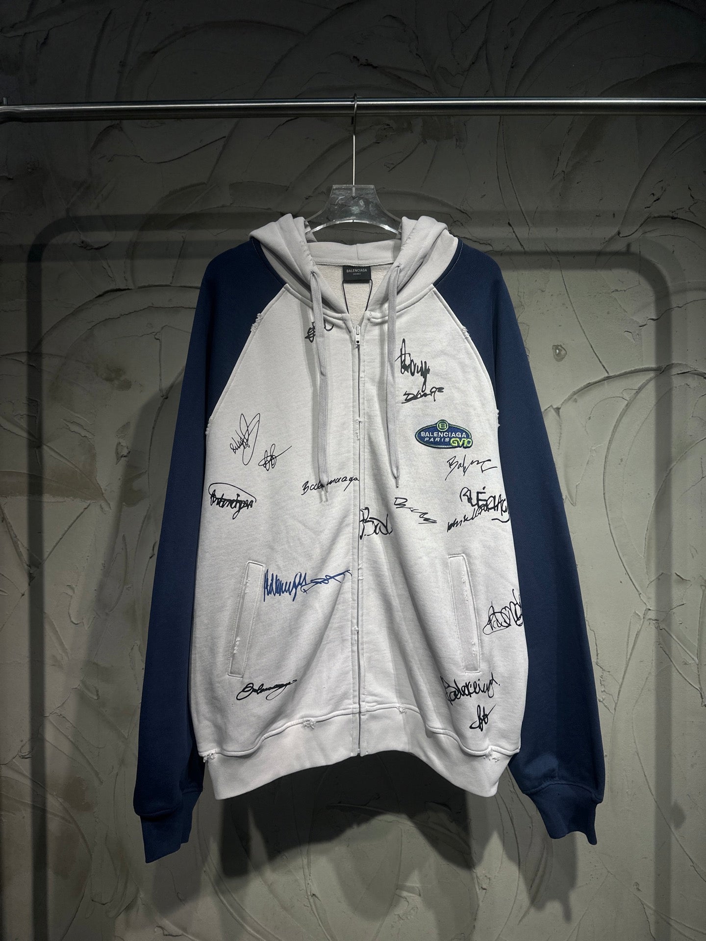Two-tone zip-up hoodie with hood, drawstrings, and all-over signature graphics