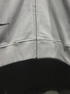 White zip-up hoodie with center zipper and stitched lower hem seam