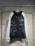 Two-tone zip-up hoodie with hood; black body, gray sleeves, white script logo prints