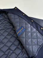 Navy quilted jacket lining with Louis Vuitton interior label.