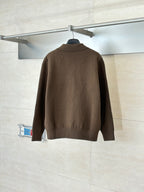 Back view of brown zip-up jacket with stand collar and gold zipper details