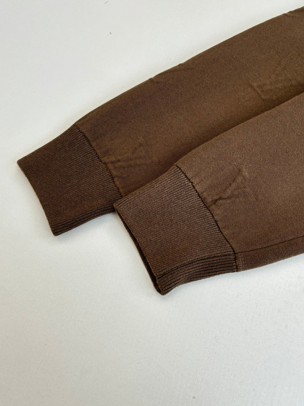 Brown jacket ribbed cuffs and stitched sleeve hem with matching fabric paneling