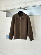 Brown zip-up jacket with stand collar and full-length gold zipper on hanger