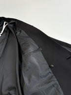Black long blazer jacket inner lining and pocket close-up.