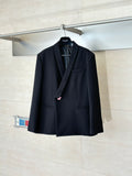 Black long blazer jacket with notch lapels and front welt pockets, hanging on a hanger.