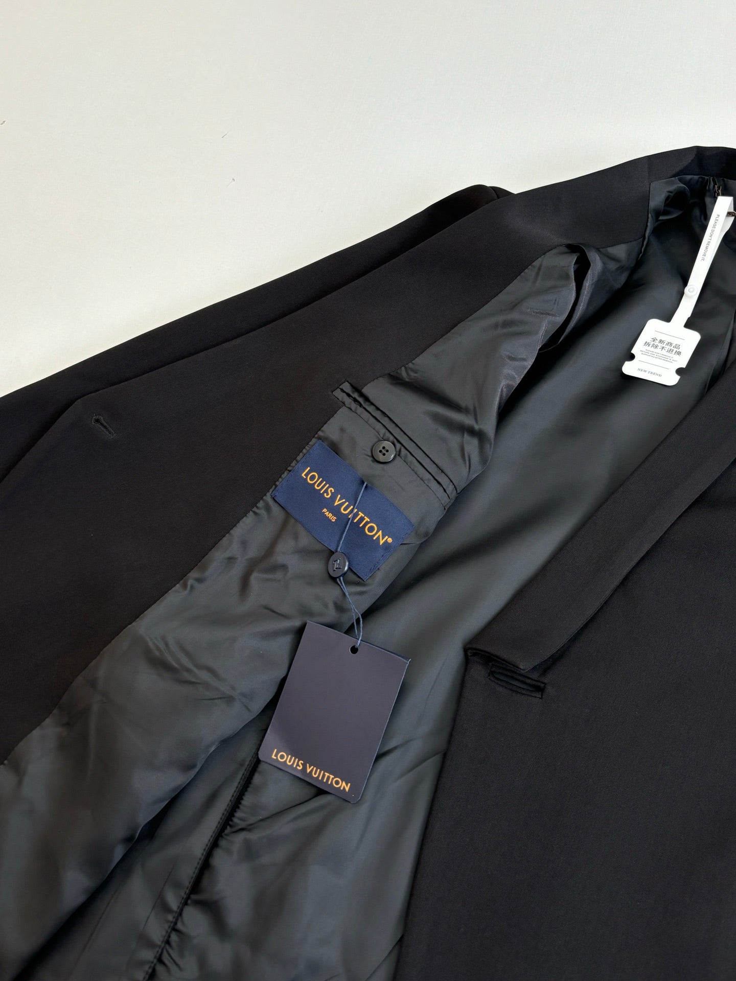 Black long blazer jacket with Louis Vuitton tag on inner lining.