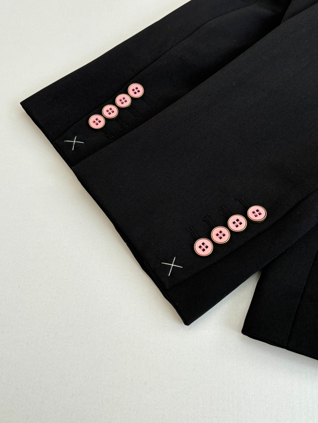 Black long trousers with button cuff detail and decorative crosses
