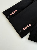 Black long trousers with button cuff detail and decorative crosses