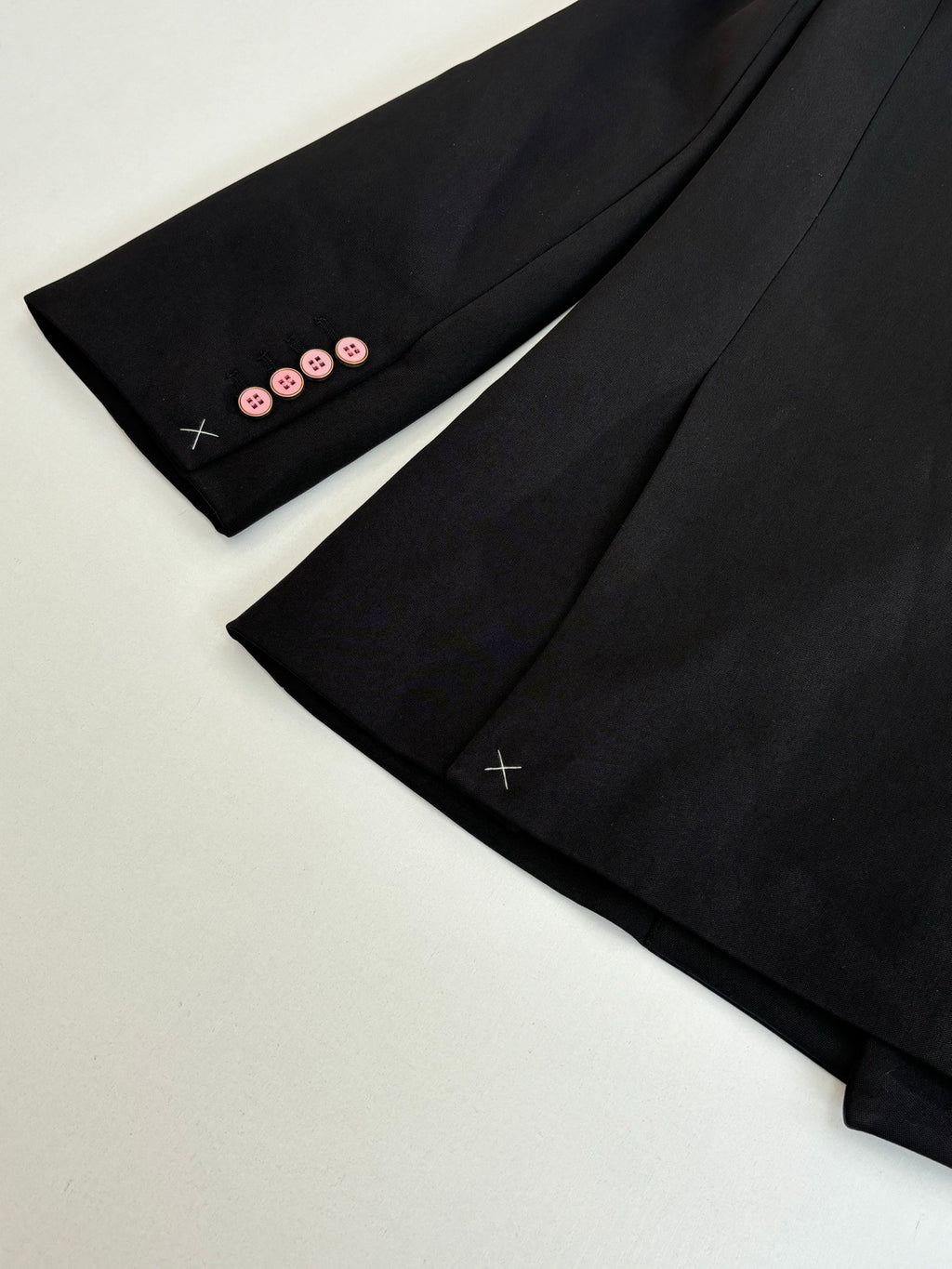 Black long trousers with pink button trim at cuffs