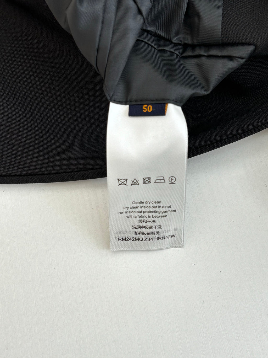 Black trouser care label with size tag inside waistband