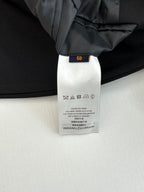 Black trouser care label with size tag inside waistband