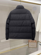 Dark long puffer jacket, back view, full-zip design with quilted panels