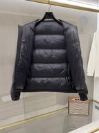 Dark long puffer jacket, front interior view with stand collar and quilted insulation