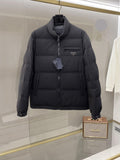 Dark long puffer jacket with front zipper and stand collar, side logo patch