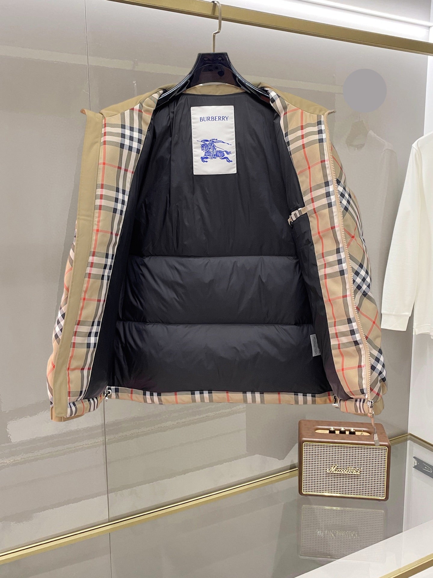 Burberry long jacket open at front, showing black quilted interior and plaid outer