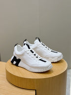 Unisex white sneakers on a round display, black stripe details, lace-up