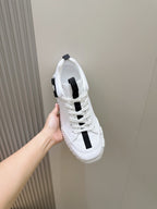 Unisex white sneakers side view with black vertical strap, lace-up