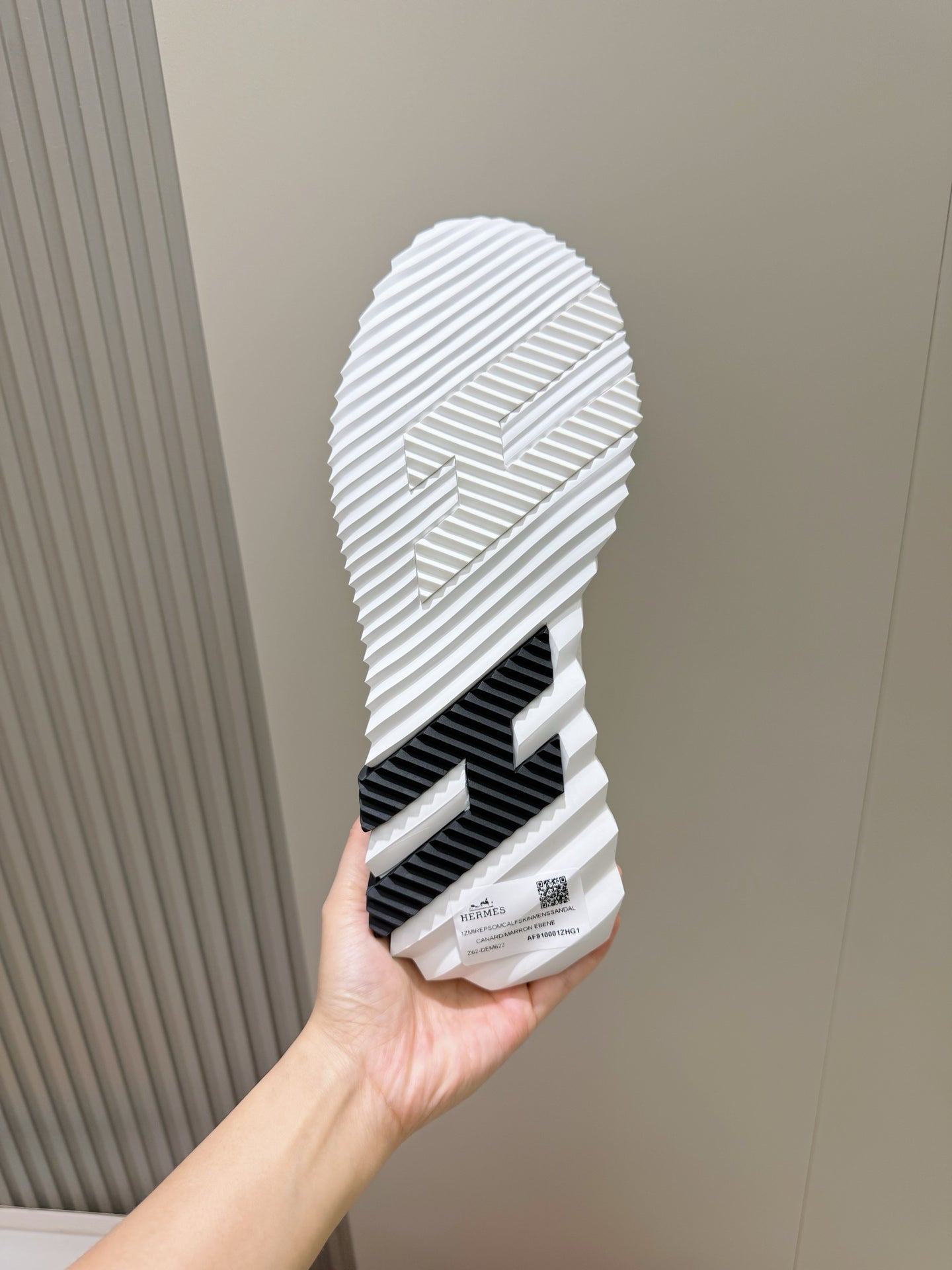 Unisex white sneaker outsole with black tread stripe pattern, ridged grip sole