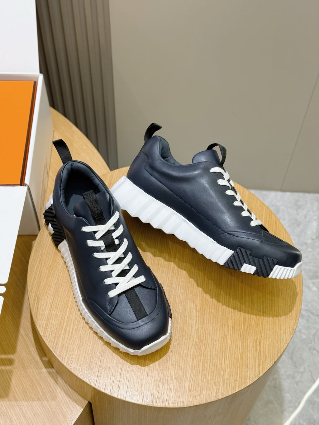 Unisex dark navy lace-up sneakers with white laces and chunky white sole