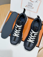Unisex dark navy sneakers with white laces and contrast paneling in box