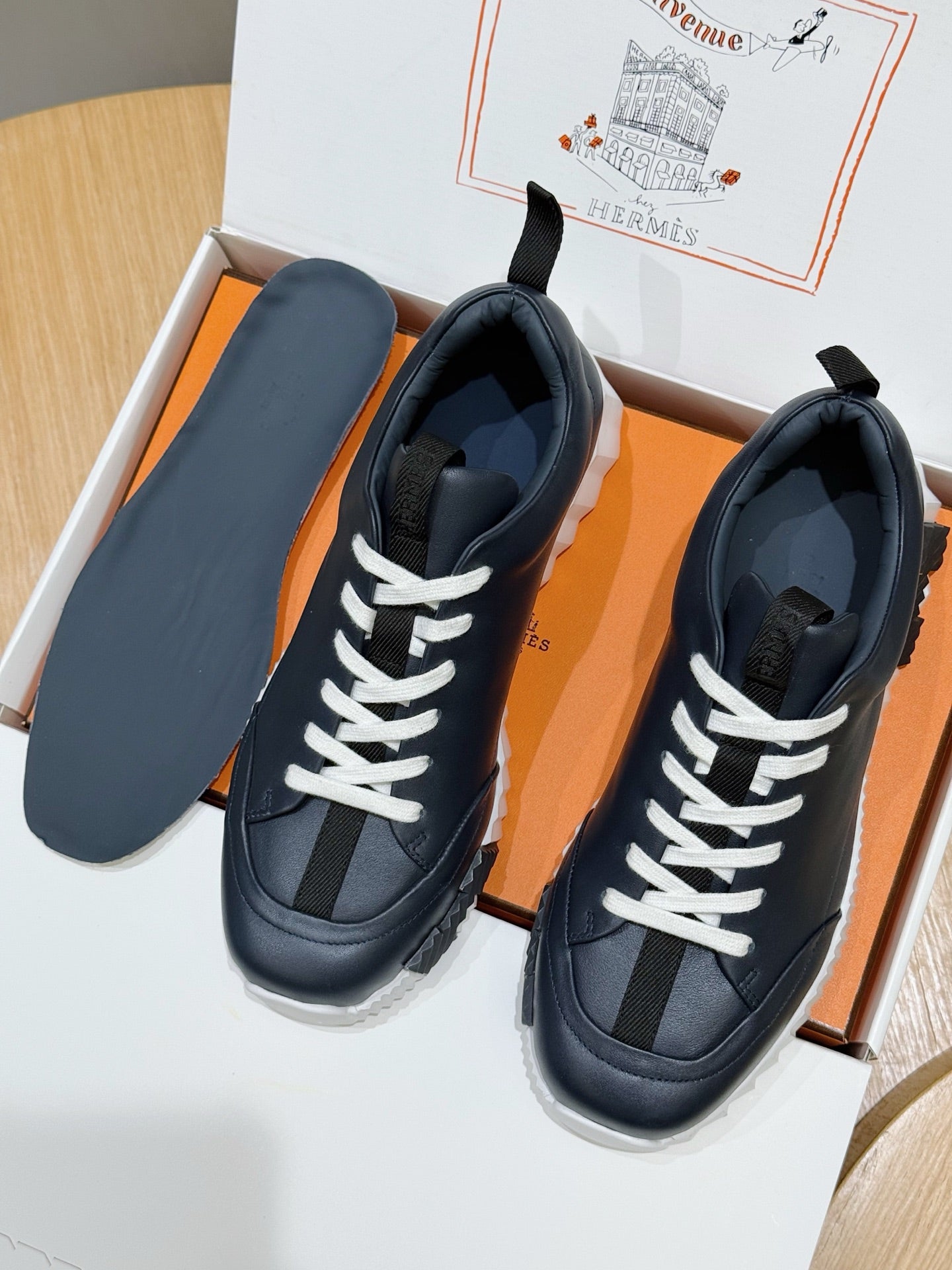 Unisex dark navy sneakers with white laces and contrast paneling in box