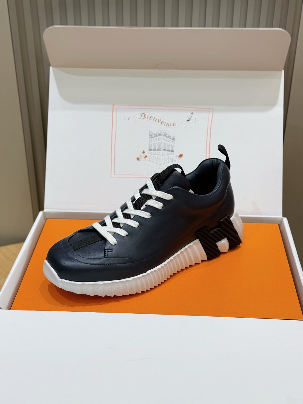 Unisex dark navy lace-up sneakers with white laces, ribbed heel tab, and thick sole
