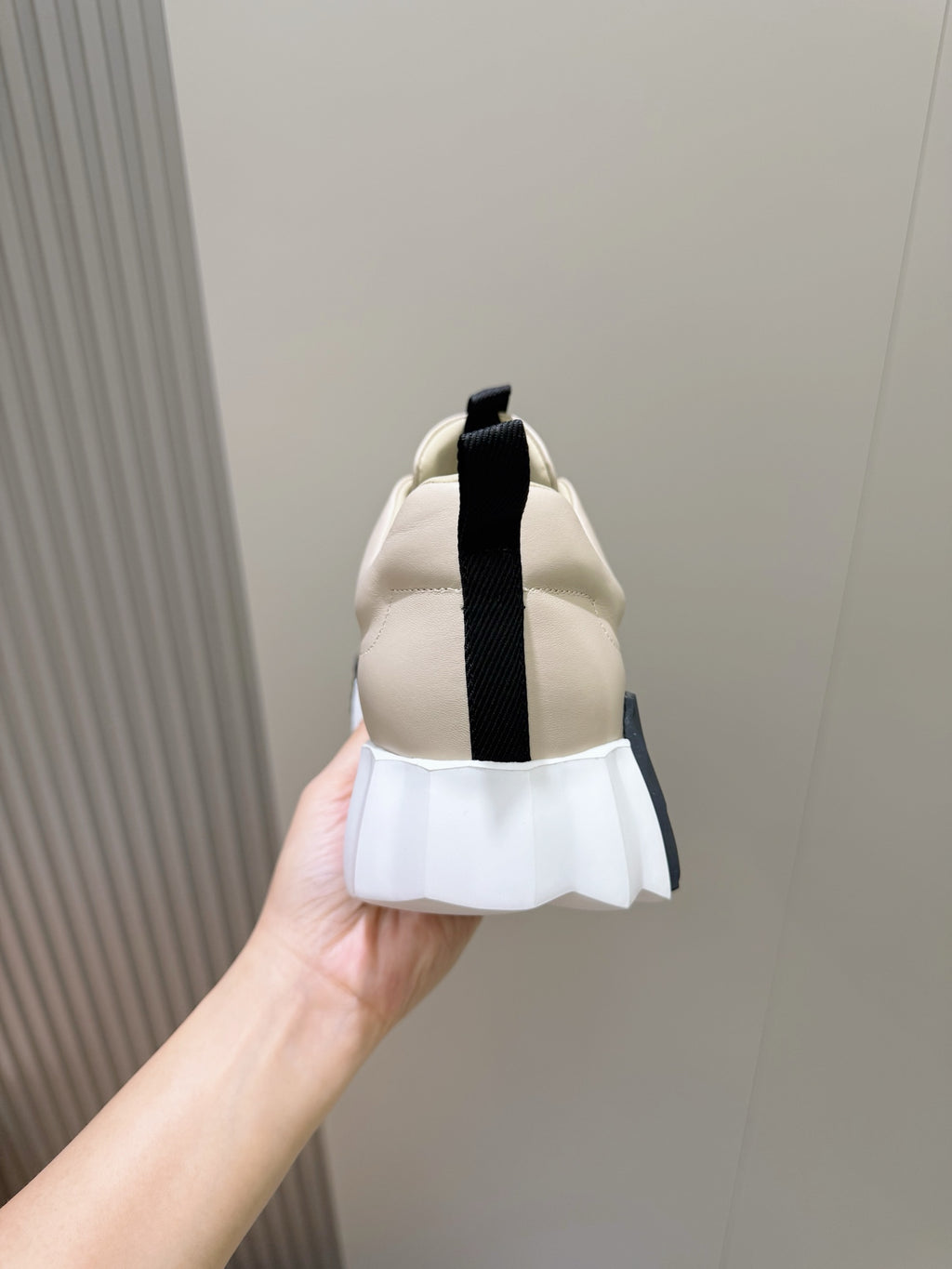 Hermes unisex sneakers heel view, light cream with black strap detail
