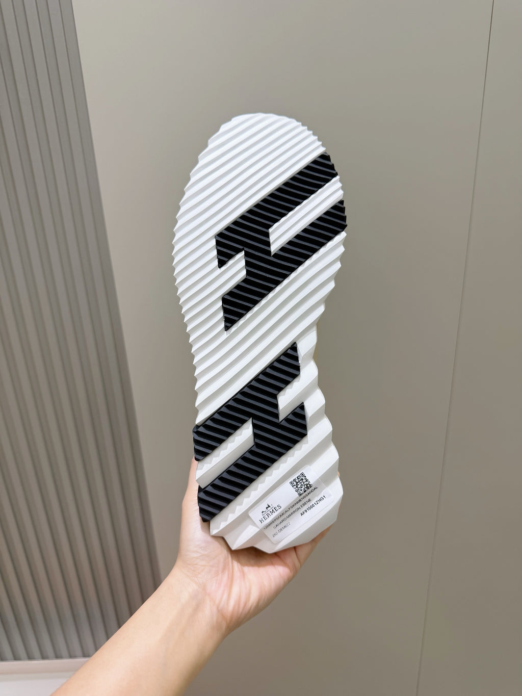 Hermes unisex sneaker outsole, ridged rubber tread with black stripe pattern