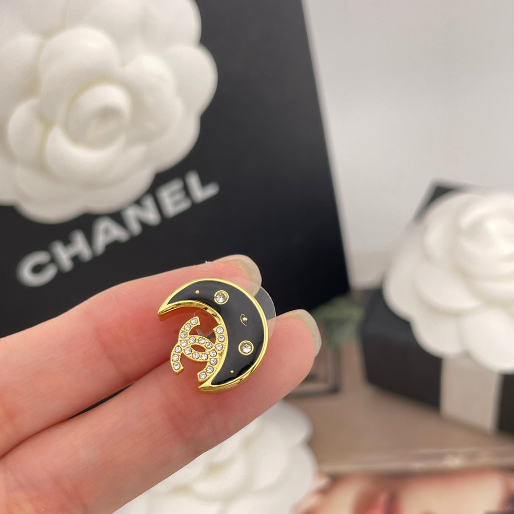Crescent moon stud earring, gold-tone outline with black enamel and rhinestones