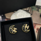 Crescent moon stud earrings, gold-tone with black enamel and rhinestone detailing