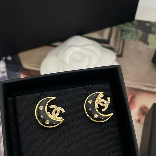 Crescent moon stud earrings, gold-tone with black enamel and rhinestone detailing
