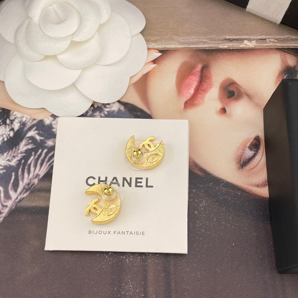 Crescent moon stud earrings, gold-tone with CC motif and rhinestone accents