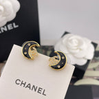 Pair of crescent moon stud earrings, gold-tone with black enamel and gem details