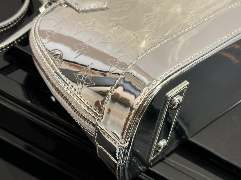 Louis Vuitton monogram handbag side panel with glossy finish and metal trim