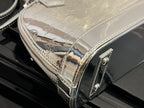 Louis Vuitton monogram handbag side panel with glossy finish and metal trim