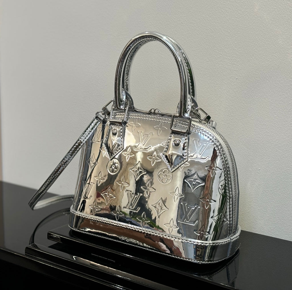 Louis Vuitton monogram handbag with top handles, silver-tone hardware and shoulder strap