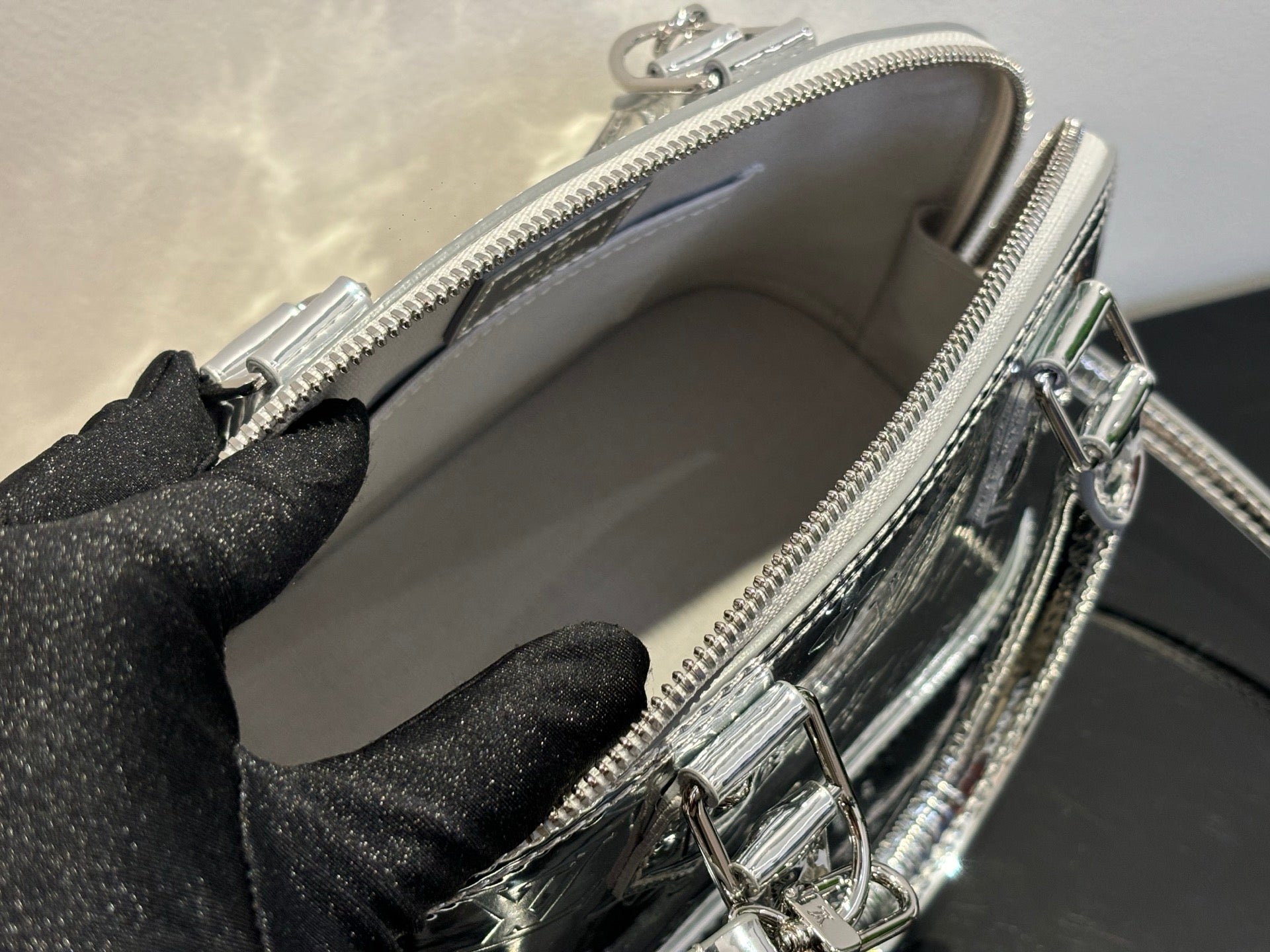 Louis Vuitton monogram handbag open top view with zip closure and interior lining