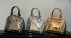 Set of three Louis Vuitton monogram handbags: silver-tone, dark, and gold-tone