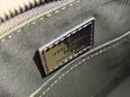 Louis Vuitton logo plaque on metallic silver handbag with zipper trim and stitching
