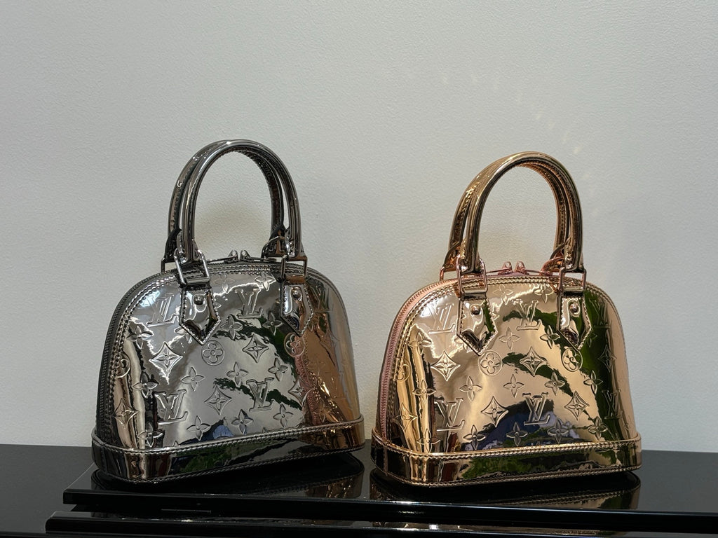 Louis Vuitton mini handbags in metallic silver and rose-gold tones, top handles and zipper