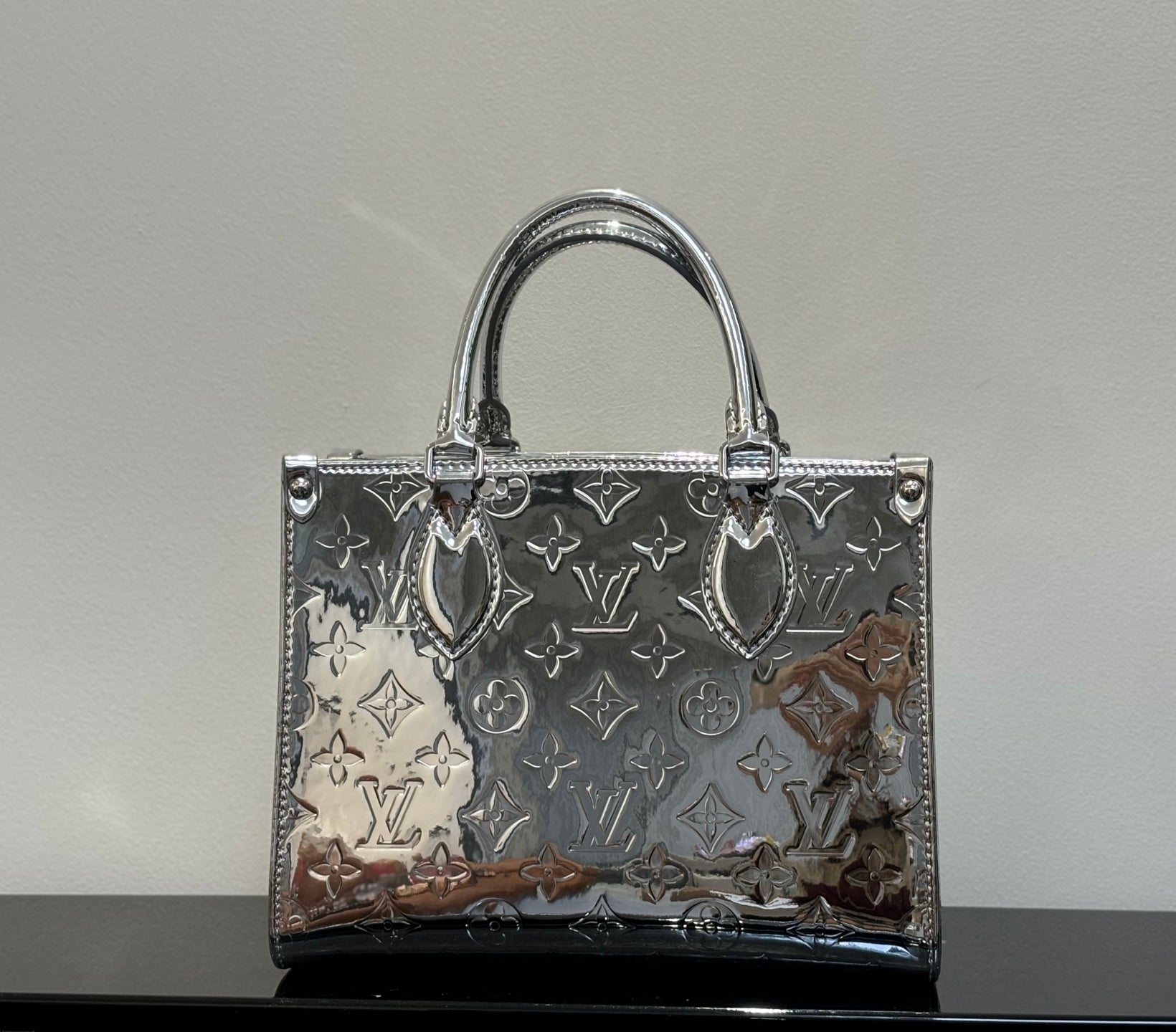 Louis Vuitton monogram tote bag with top handles, dark brown with metallic accents