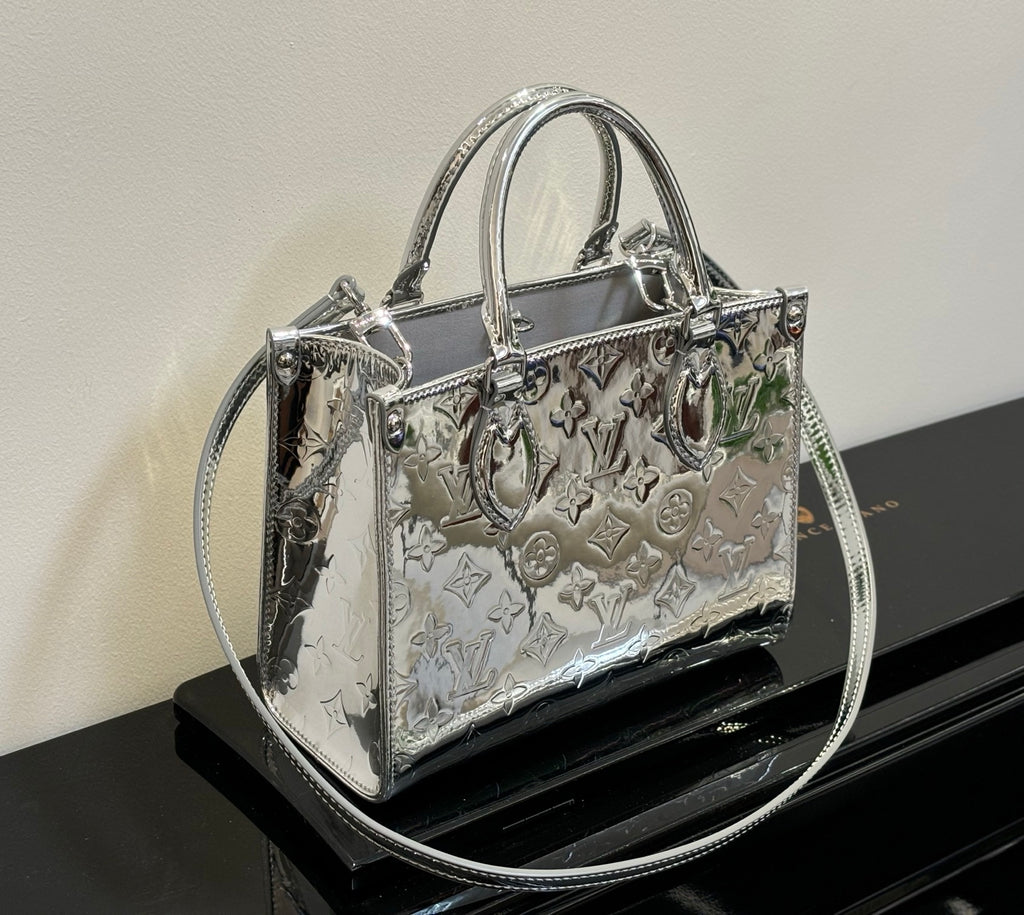 Louis Vuitton monogram tote bag with top handles, metallic silver sheen and embossed motifs