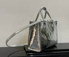 Louis Vuitton monogram tote bag with top handles and long shoulder strap, metallic finish