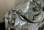 Louis Vuitton monogram handbag with front clasp hardware and curved handle, metallic silver